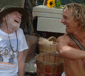 Willie Nelson & Matthew McConaughey sharing a laugh outdoors